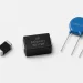 Black glass-coated MLV chips, a molded SMD MOV, and blue radial through-hole MOVs shown side by side