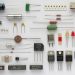 Real resistors capacitors diodes transistors integrated circuits and a relay arranged on a white background