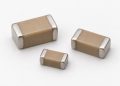 Three unbranded two-terminal MLCC ceramic capacitors arranged naturally on a white background