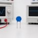 Metal oxide varistor between separate AC and DC continuous-voltage test sources