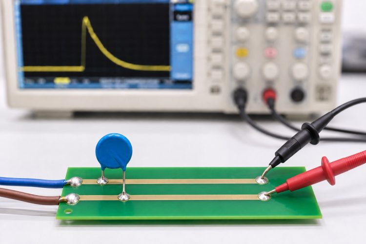 Oscilloscope probes measuring surge residual voltage between the protected node and local return after an MOV