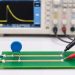 Oscilloscope probes measuring surge residual voltage between the protected node and local return after an MOV