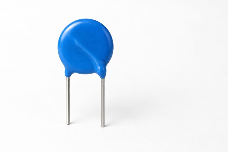 Blue radial-leaded disk MOV on a white background