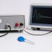 MOV beside a pulse generator and oscilloscope showing repeated surge waveforms