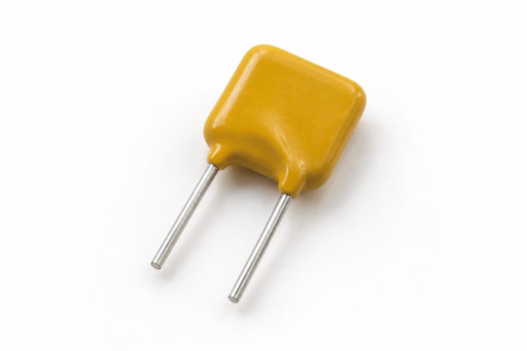 Unbranded yellow radial-leaded PPTC resettable fuse on a white background