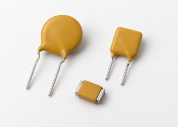Two unbranded radial-leaded PPTCs and one surface-mount PPTC arranged naturally on a white background